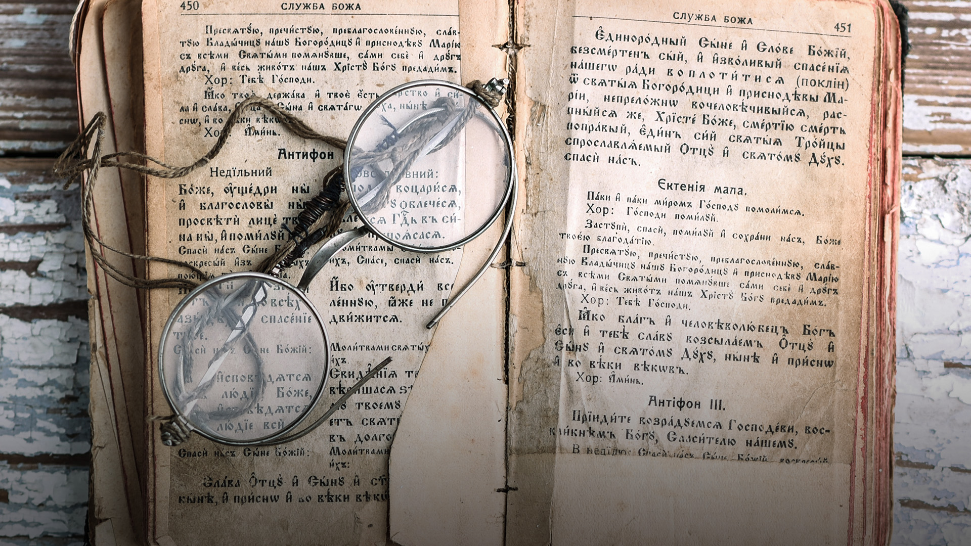 broken glasses and ancient prayer book with slavic text