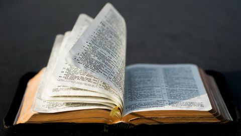 Bible with pages flipping in the wind