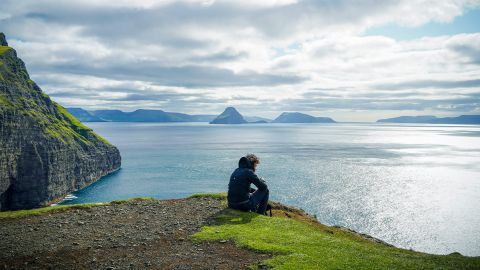 A man looking over a lake